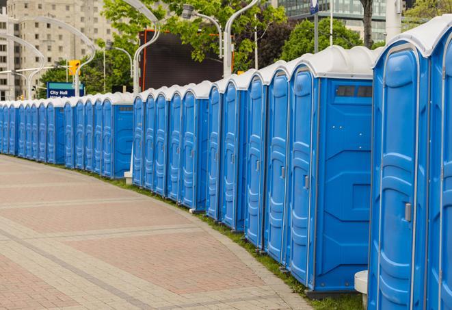 a row of portable restrooms set up for a large athletic event, allowing participants and spectators to easily take care of their needs in Bauxite AR